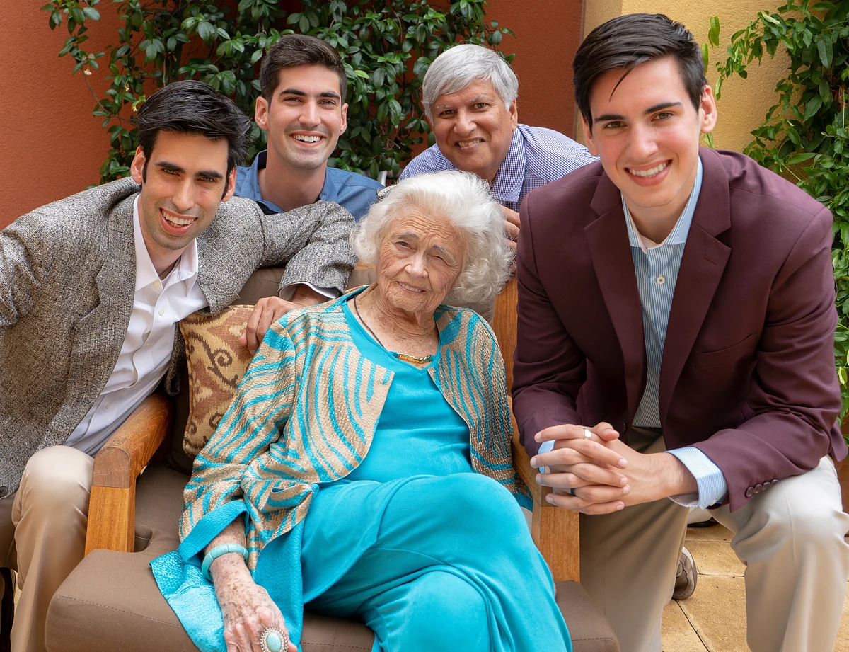 four students gathered around grandmother